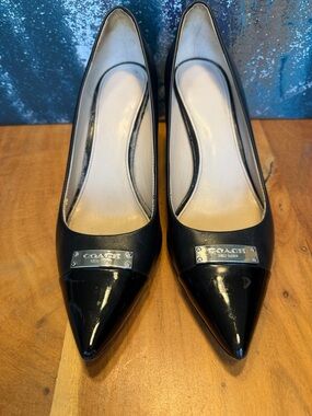 Coach Black Pointed Toe Leather Pumps with Silver Logo Plate